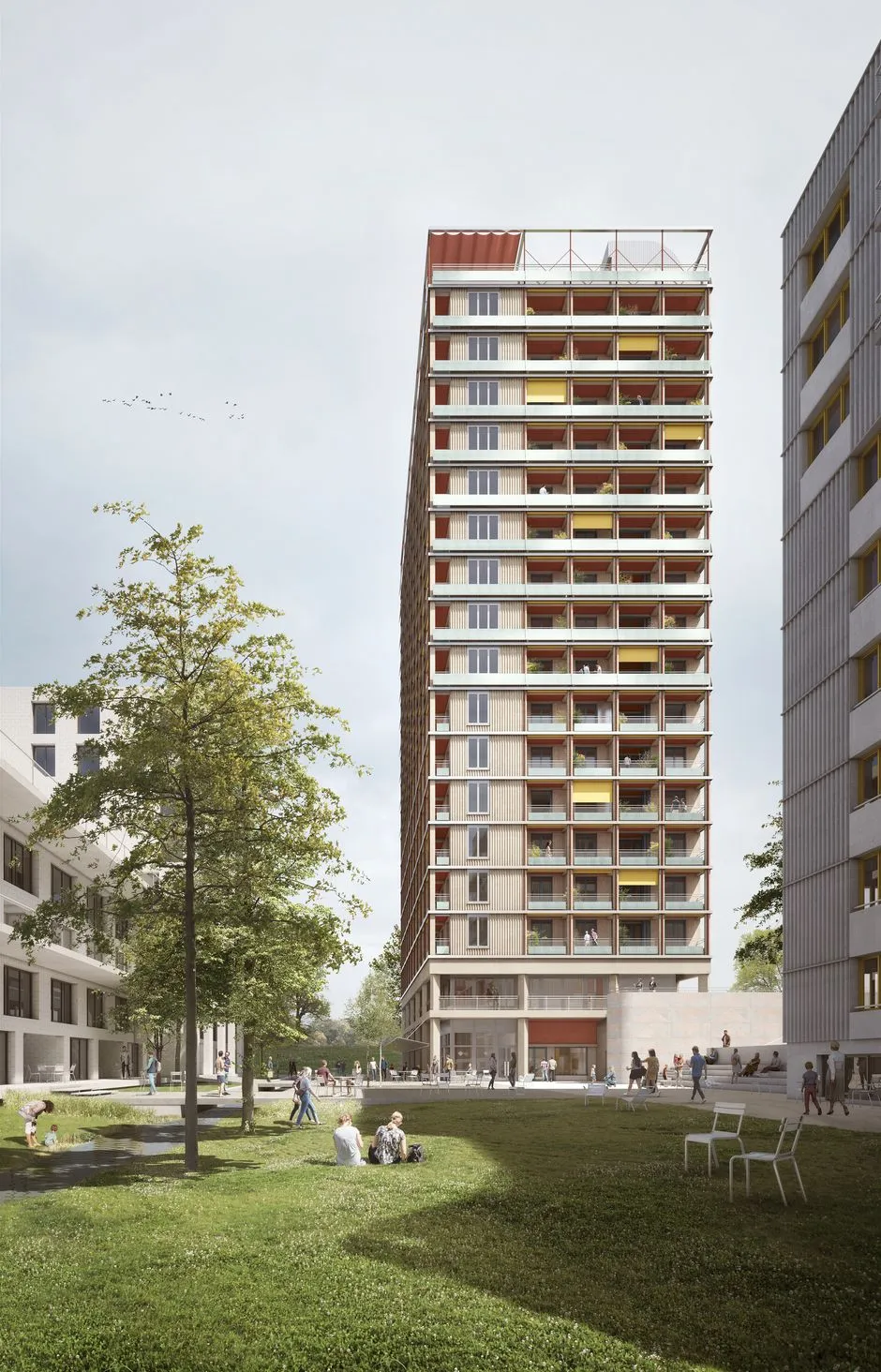 Hochhaus mit einem Baum im Vordergrund